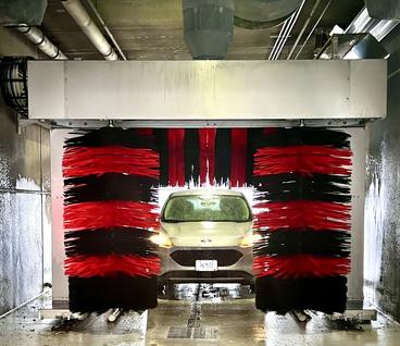 Car going through carwash at fleet building