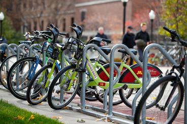 2 branded Gopher Bikes sitting at a bike parking area